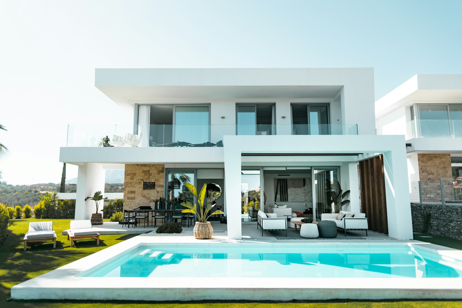 Sunlit contemporary residence with a pool and tropical landscaping